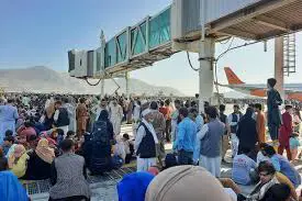 Panicked people at Kabul airport cling to plane taking off
